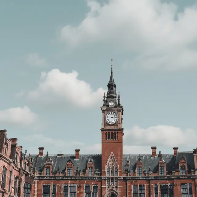 Clock tower showcasing mortgage, credit card, auto loan, personal loan, student loan, and business loan default timelines