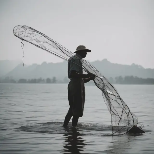 Visualizing the difference in production between a fisherman with a net (capital goods) vs. a pointy stick
