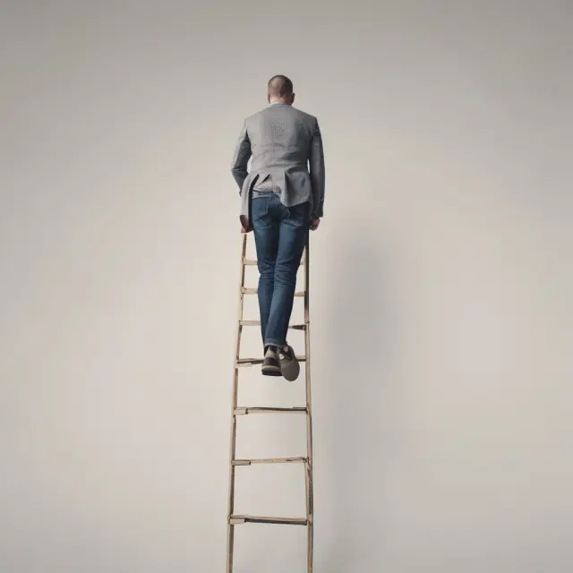 Man ascending a ladder composed of monthly mortgage payments, symbolizing debt repayment through fully amortizing payments