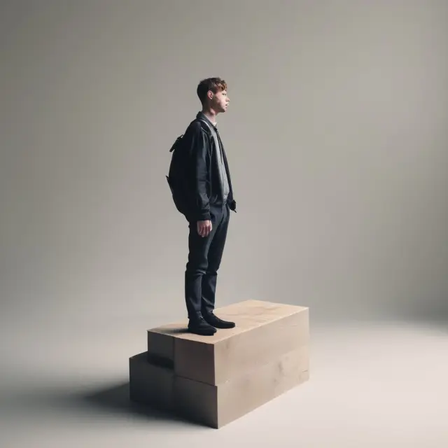 A person contemplating loan decisions on a balancing scale with 